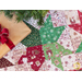 Tree skirt with patchwork and geometric star design made of red, white, and green, Christmas themed fabrics.