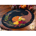 Wool placemat with appliqué of a horn filled with fruits and a pumpkin.