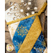 A decorative holiday stocking with gold and blue fabric featuring snowflake patterns, placed against a stone background. The stocking is adorned with a sparkling star-shaped decoration on top.