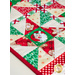 Table runner with triangle pinwheel design in Christmas themed Santa fabrics in red, white, and green.