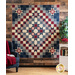 Quilt with Ohio stars in a diamond shape design made of red, white, and blue floral printed fabrics.