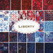 A collage of patterned fabrics featuring various designs in red, white, and blue, including stars, fireworks, and American flags, with the word Liberty prominently displayed in the center.