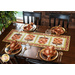 Table runner with acorn pieced blocks made with brown and cream floral fabric prints on a table with matching napkins.