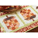 Table runner with acorn pieced blocks made with brown and cream floral fabric prints.