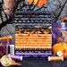 A stack of various patterned fabric rolls in black, orange, and purple. The patterns include Halloween themes such as pumpkins and spooky designs. Surrounding the fabric are jars filled with purple and orange items, and spools of thread in coordinating colors. Black tree branches and autumn leaves are visible in the background.