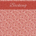 Pink fabric with red and white square outlines tossed all over with small red daisies and dots.