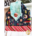 towel made of blue winter themed fabrics with candy cane striped accents.