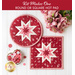 Round and square folded star hot pads made with red and pink floral fabrics on a white countertop with a bouquet of pink roses nearby and a heart shaped dish full of pink and red buttons