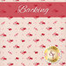 Pale pink fabric with small red and pink flowers clusters all over and a pink banner with the word 