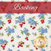 White fabric with clusters of blue flowers and red cherries with green leaves with a red banner and the word 