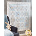 Photo of a cream, blue, and grey quilt that features rabbits from the children's book, 