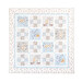 Photo of a cream, blue, and grey quilt that features rabbits from the children's book, 