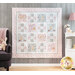 Photo of a cream, pink, and grey quilt that features rabbits from the children's book, 