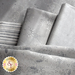 A collection of gray fabrics with various patterns, including snowflakes and swirls, is neatly arranged. Some fabrics have a shiny texture, while others feature a striped design. A logo for Shabby Fabrics is also visible.