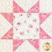 close up of a sawtooth star quilt block made with pink and cream floral fabrics 