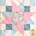 close up of one quilt block featuring a classic star pattern made with soft floral pink, blue, and cream fabrics