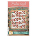 A colorful quilt titled Psalms Quilt, featuring a floral design with various patterns, bordered with turquoise fabric. The quilt is displayed against a wooden background, with a website link at the bottom for Shabby Fabrics.