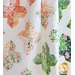 A close-up of a colorful quilt featuring star and floral patterns on a white background.