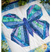 Close up photo of a blue and green butterfly made with foundation paper piecing techniques