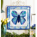 The completed Foundation Paper Piecing Kit - June, a beautiful butterfly colored in blue, teal, and indigo fabrics, hung on a craft hanger and staged with a coordinating décor.