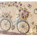 A decorative embroidery design featuring a bicycle with a basket filled with flowers, surrounded by colorful floral patterns and butterflies on a light background.