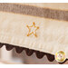 A close-up of a cream-colored fabric with brown stripes, featuring an embroidered yellow star and a scalloped brown edge. The bottom right corner has a logo from Shabby Fabrics.