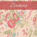 Warm toned cream fabric with pink, blue and gray flowers all over and green leaves with a pink banner at the top of the image with the work 