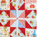 Close up of one quadrant of the quilt showing a sawtooth star in red fabric with strawberry themed blue and cream fabrics