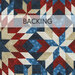 fabric with red, white, and blue geometric designs and a pale banner at the top that reads 