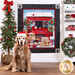Photo of a finished panel quilt featuring golden retriever puppies in front of a red truck in a snowy Christmas scene hanging on a white paneled wall with a Christmas tree on one side and matching decor on a white shelf on the other with a golden retriever wearing a Santa hat in the foreground.
