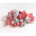 Reversible cloth napkins with red gingham fabric on one side and blue floral fabric on the other, in silver napkin rings.