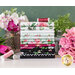 white, mint, magenta, and black floral fabric stacked on a table surrounded by flowers