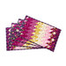 Four quilted placemats arranged in a stack, featuring a gradient pattern of purple, pink, and yellow with floral designs.