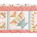 close up of one edge of a pastel floral quilt showing floral motifs and stitching detail