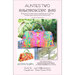 The front of the Kaleidoscope Bag Pattern by Aunties Two showing a colorful tote bag in front of shrubs