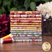 A stack of the fabrics included in the Nature Sings FQ set, with flowers and a flower pot and thread.