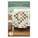 front cover of the trip around the world crib quilt pattern showing a finished project and pattern name.