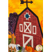 A close up photo of an autumn-themed wall hanging featuring a red barn, wagon full of pumpkins, and a sheep.