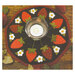 A round decorative table mat featuring a pattern of red strawberries and white flowers, with a small glass candle holder in the center.