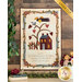 A quilted wall hanging featuring a tree with hearts, a house, and a fence. The design includes a bird, flowers, and text that reads, Lord, let there be love in our hearts, harmony in this home, peace in our land. The quilt is framed by decorative borders and has a label in the corner that says Shabby Fabrics.