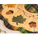 Close up photo of an applique leaf, acorns, and embroidery detail on an autumn-themed table topper