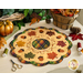 Photo of an autumn themed table topper on a white table with fall decor all around including leaves, a gold pumpkin, and sewing notions.