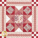 Close up photo of one block of the patchwork quilt made with red and cream floral fabrics