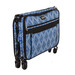 Blue patterned rolling suitcase with a zippered front pocket, shown in a collapsed position.