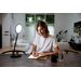 Woman using a TriSun Lamp to write in a journal