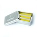 Silver tin container of SewTites magnets, with alternating yellow and silver sewing magnets inside.