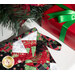 Close up photo of the top of the Christmas stocking with a red wrapped gift and pine branches in the foreground