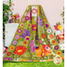Photo of a colorful floral quilt draped over a ladder leaning against a pale pink wall with a small white cabinet on one side and baskets of flowers all around