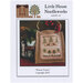 Front of pattern showing the completed small cross stitch ornament staged with a reindeer decoration