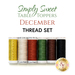 Image features a collection of six spools of thread arranged horizontally. The colors include gold, cream, rust orange, dark green, dark brown, and black. At the top, the text Simply Sweet Table Toppers is displayed, with DECEMBER THREAD SET in larger letters underneath. A logo for Shabby Fabrics appears in the bottom right corner.